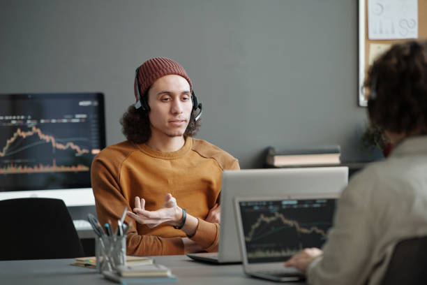 istock Confident young helpdesk operator sitting in front of laptop 1465821032
