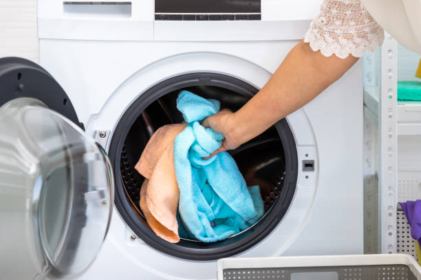 istock Senior Asian woman loading towel clothes into front load washing 1465822624