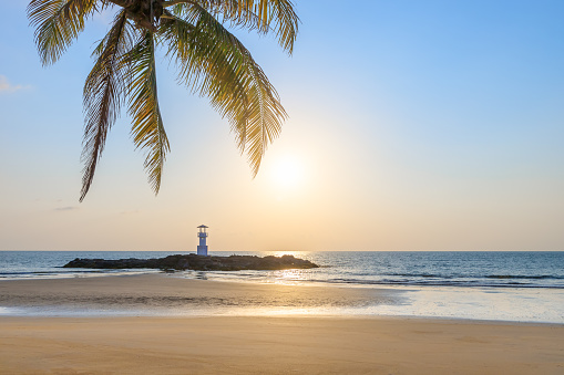 Khao Lak beach and light beacon or lighthouse for navigation with coconut tree leave, travel destination and resort near Phuket, Phang-Nga, Thailand