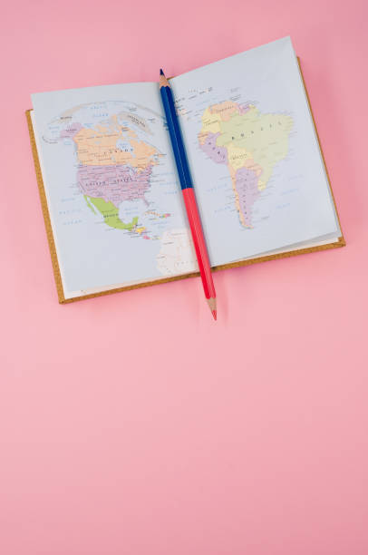 istock Vertical shot of a two-sided pen in a notebook on a pink surface 1465823434