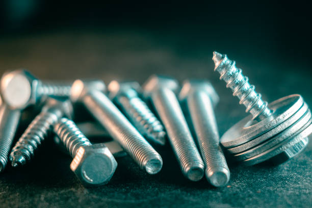 istock Pile of screws on a black background 1465825653