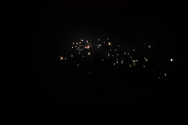 A dark black background with flashing light trails for wallpapers