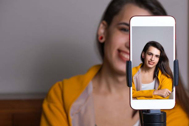 istock Happy female blogger doing a live streaming with smartphone 1465827061