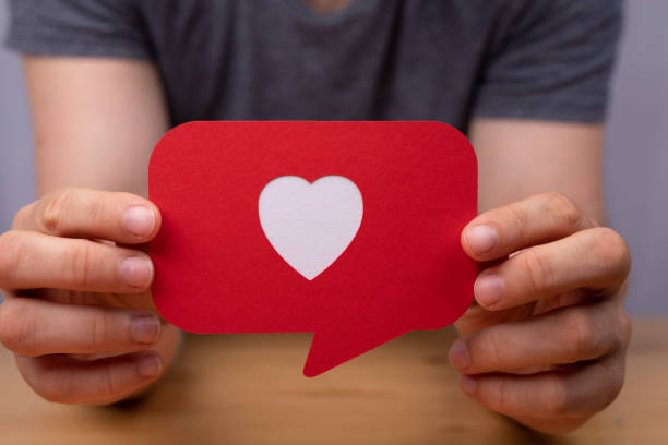 istock Hand holding a red speech bubble with heart - Valentine concept 1465827553