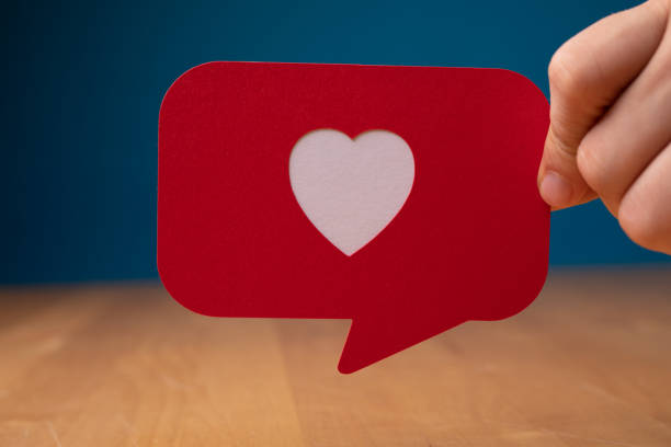 istock Hand showing a red speech bubble with heart - Valentine concept 1465827575