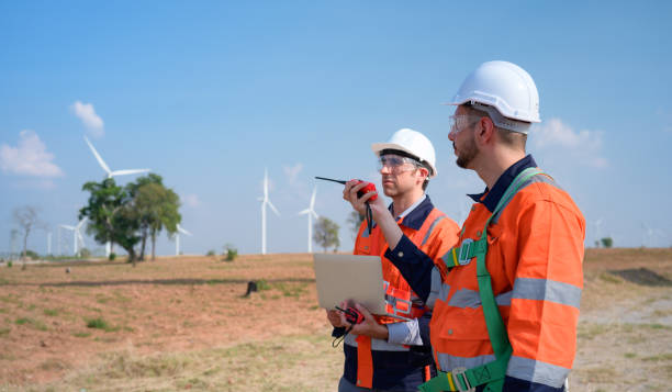 istock Surveyor and engineer Examine the efficiency of gigantic wind turbines that transform wind energy into electrical energy that is then used in daily life. 1465829507