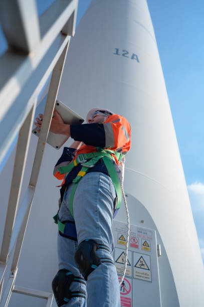 istock Engineer at natural energy wind turbine site Must use a computer to control check for accuracy in work 1465829528