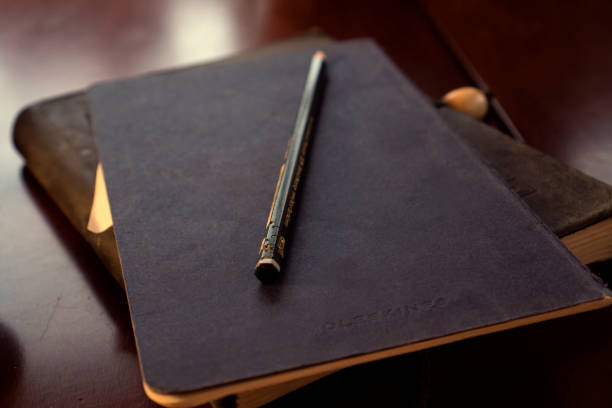 istock Closeup of a pen on notepads on the table with a blurry background 1465830248