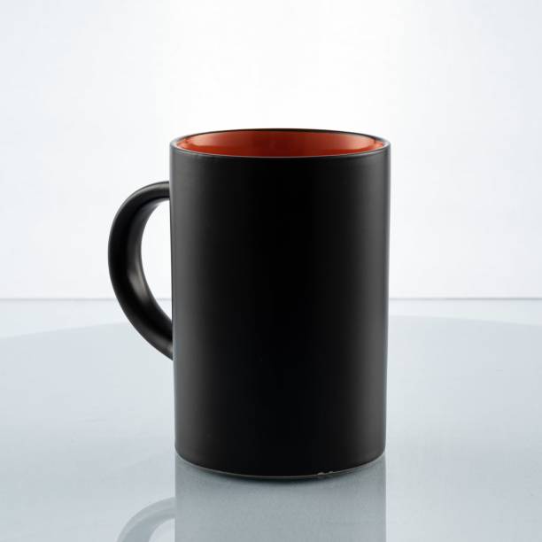istock Black cup with orange for casual breakfast on a white background and a glass table 1465831182