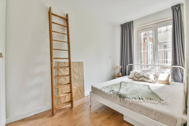 istock Beautiful furnished bedroom interior with windows 1465831283
