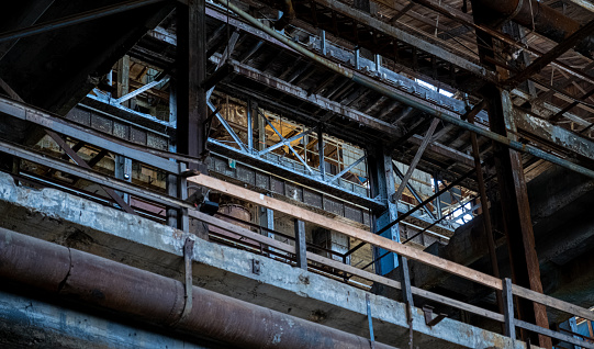 A low angle of an industrial building bacony with pipes
