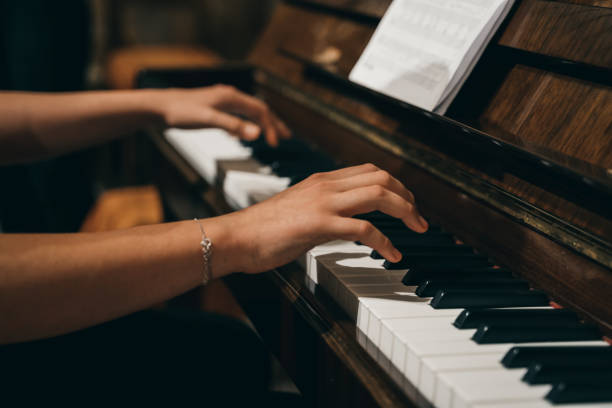 istock Female's hands playing the piano 1465831847