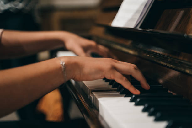 istock Female's hands playing the piano 1465831860