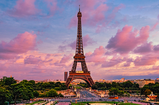 The Eiffel Tower against a mesmerizing pink cloudy sky in Paris, France