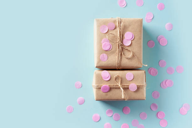 istock Pink gift boxes with confetti on blue background 1465837165