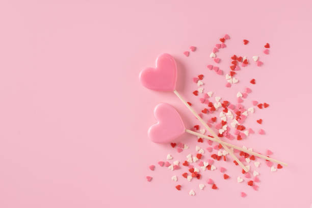 istock Candy pink lollipops with red gift box on pink background 1465837714