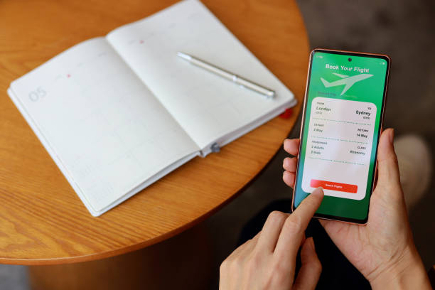 istock Woman using smartphone to book flight tickets and plan holiday 1465843541
