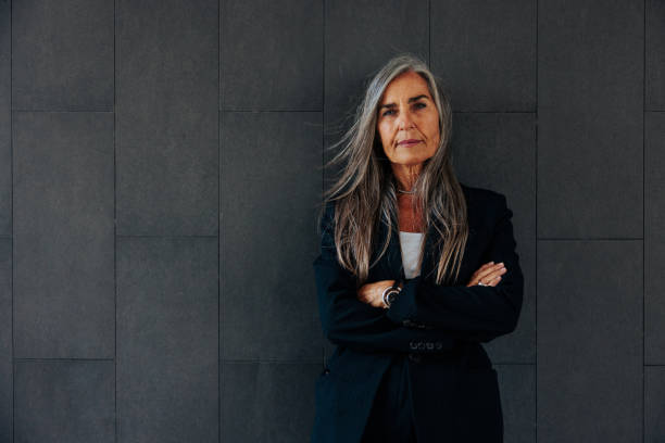 istock Senior businesswoman on dark background with copy-space. 1465843956