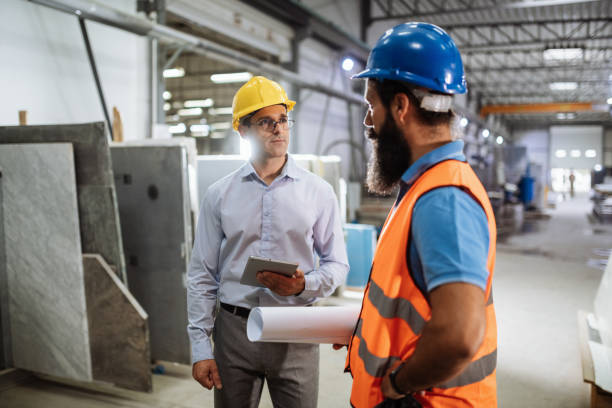 istock Employees in factory talking 1465845145