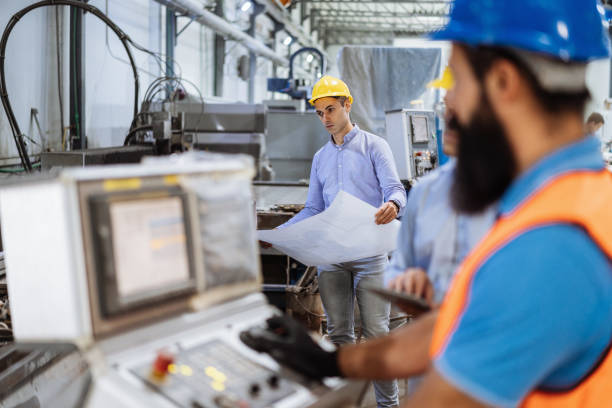 istock Group of engineers and contractors using robots and automated production process in factory 1465845924