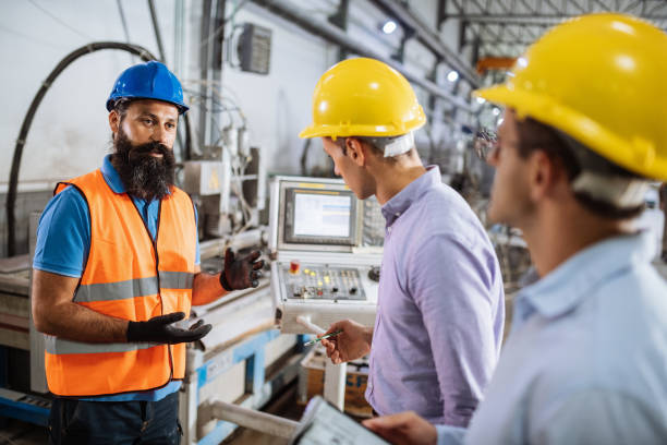 istock Group of engineers and contractors using robots and automated production process in factory 1465846050