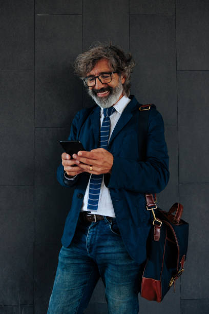istock Senior businessman using cellphone. 1465846454