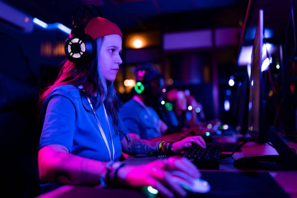 istock Concentrated female gamer playing massively multiplayer online game on PC. 1465846987