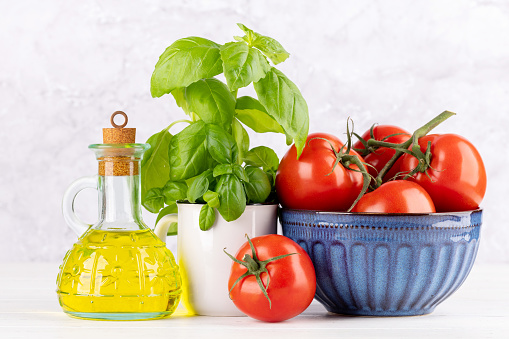 Ingredients for cooking. Italian cuisine. Tomatoes, olive oil, basil