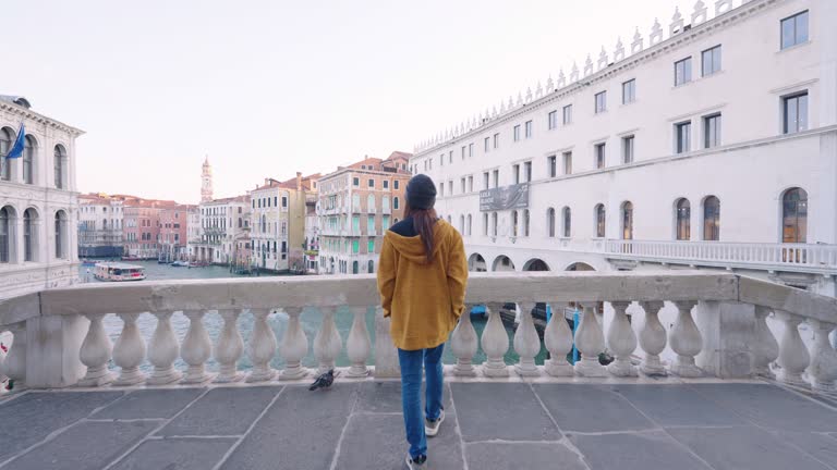 Woman walking on the bridge in Venice,Italy.