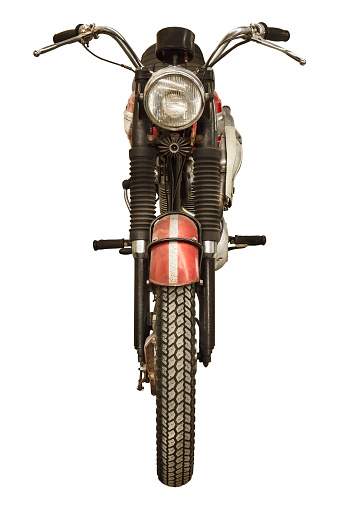 Front view of a vintage seventies English red motorcycle isolated on a white background