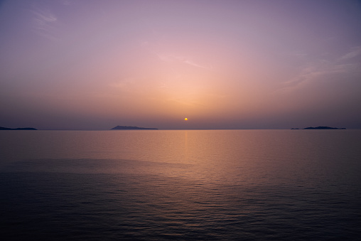 Beautiful orange sun setting over the horizon at sea
