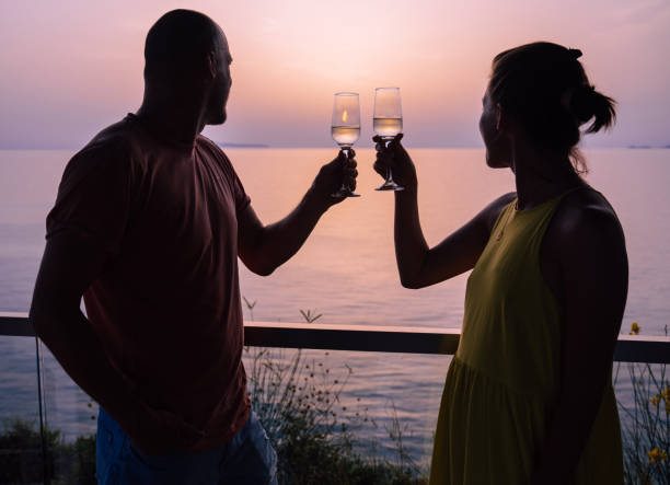 istock Romantic couple toasting and drinking champagne at a beach 1465866645