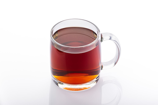 Two tea bags in a large cup against a white background