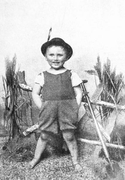 istock Boy at the fence with tyrolean hat, hands in pockets, the future boss 1465873392