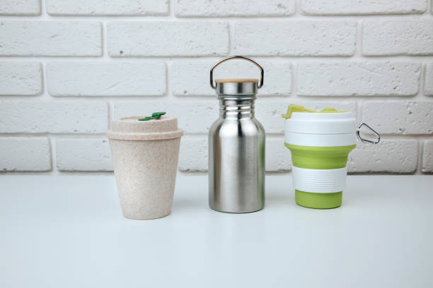 istock Set of devices for cold and hot drinks. Zero waste concept. A tin bottle for water and a mugs for coffee, tea on a white table 1465875029