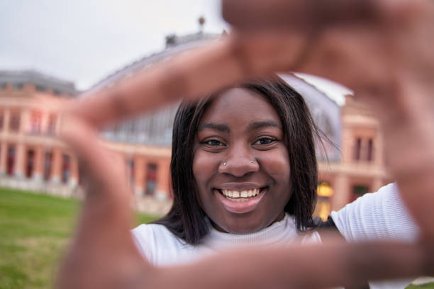 istock happy african american woman making a frame with her hands 1465875248