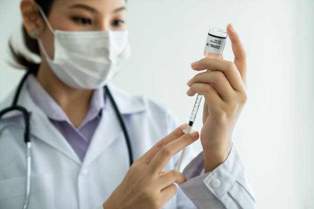 istock Skillful doctor prepare vaccine proficiently before injection . Covid 19 and coronavirus vaccination center service concept . 1465878890