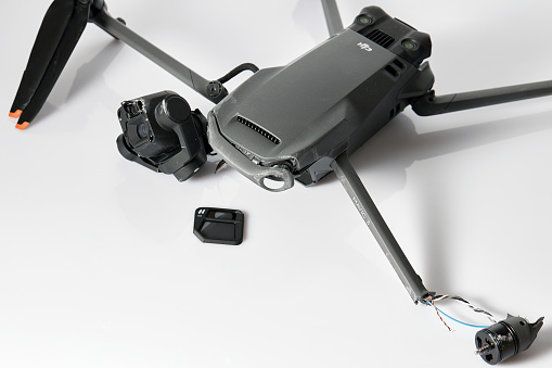 Drone DJI Mavic 3 after crashed on a white background. Drone after falling from a height. Broken gimbal camera and drone motor arm after crash. 08.05,2022. Rostov region, Russia.