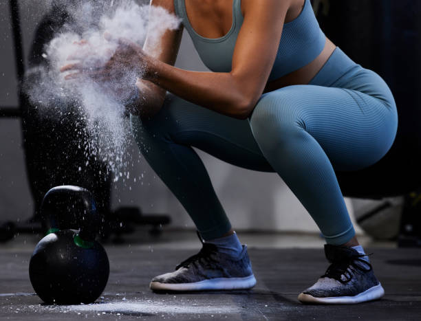 woman, hand powder and kettlebell for workout, exercise and fitness in the gym, start and prepare for healthy lifestyle. female athlete, hands and weight training, body builder and power performance - kettle bell exercising healthy lifestyle sports clothing imagens e fotografias de stock