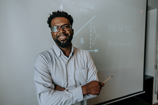 Portrait of a teacher teaching math looking at camera