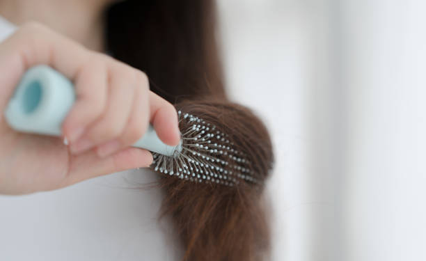 istock Woman brushing her hair with comb 1465889022