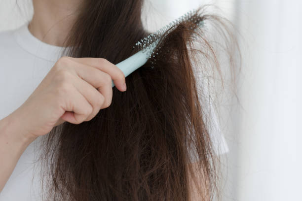 istock Woman brushing her hair with comb 1465889427