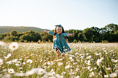 Cute kid girl in chamomile field outdoor