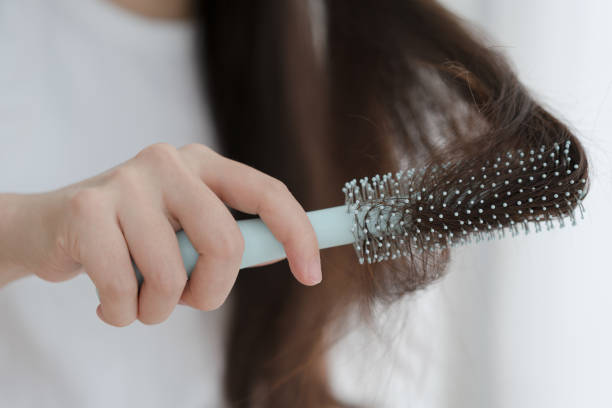 istock Woman brushing her hair with comb 1465890672