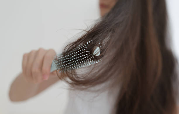 istock Woman brushing her hair with comb 1465890915
