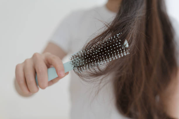 istock Woman brushing her hair with comb 1465890916
