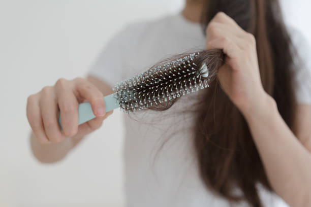 istock Woman brushing her hair with comb 1465890917