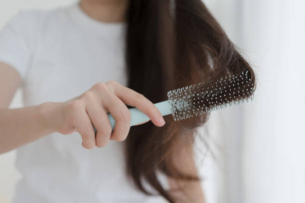 istock Woman brushing her hair with comb 1465890918