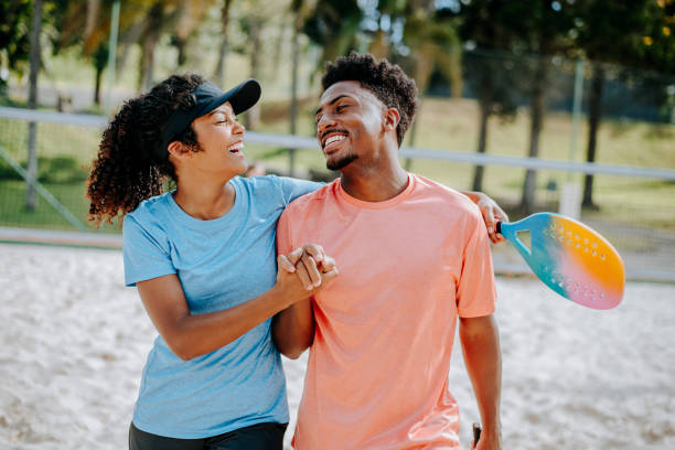 istock Couple playing beach tennis 1465896178