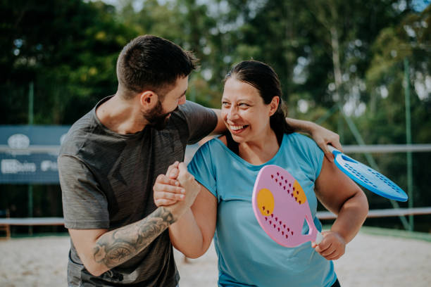 istock Couple playing beach tennis 1465896446